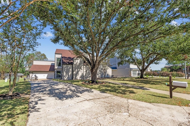 view of front of house with a garage and a front lawn