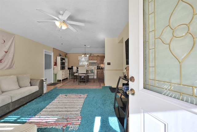 carpeted living room with ceiling fan