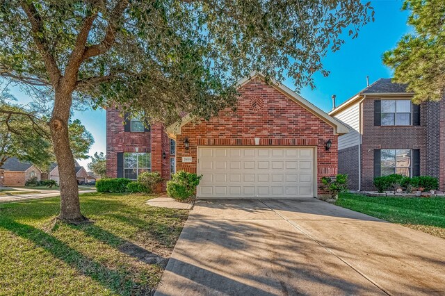 front facade with a front yard and a garage