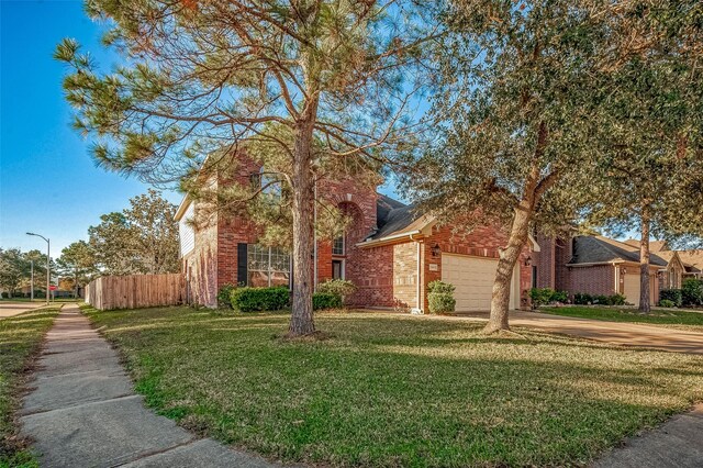 view of front facade with a garage and a front lawn