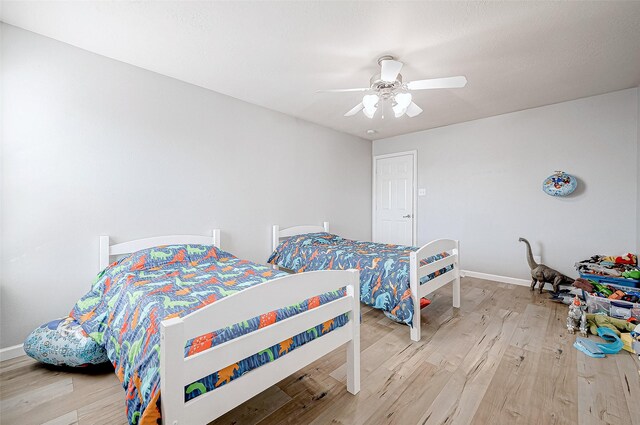 bedroom with ceiling fan and wood-type flooring