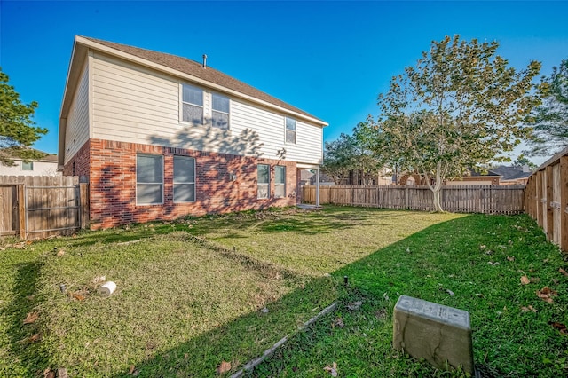 rear view of property with a lawn