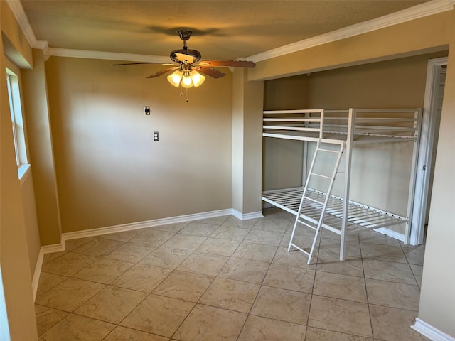 unfurnished bedroom with ceiling fan, crown molding, and light tile patterned floors