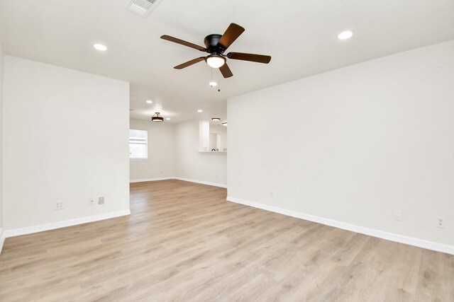 empty room with light hardwood / wood-style flooring and ceiling fan