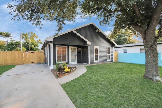 bungalow-style home with a front lawn