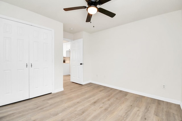 unfurnished bedroom with ceiling fan, light hardwood / wood-style floors, and a closet