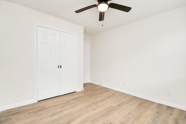 unfurnished bedroom featuring ceiling fan, light hardwood / wood-style floors, and a closet