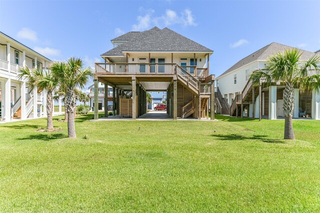 back of house featuring covered porch, a carport, and a lawn