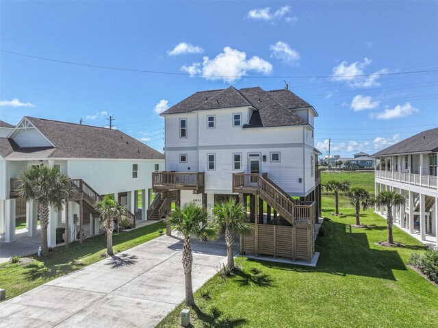 rear view of house featuring a yard