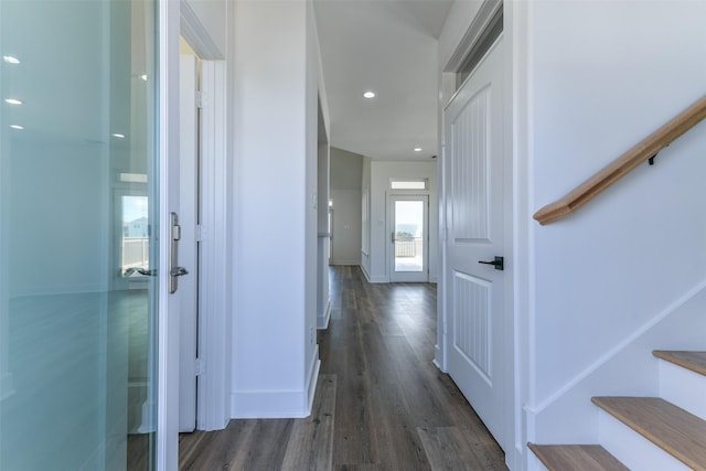 hallway with dark hardwood / wood-style flooring