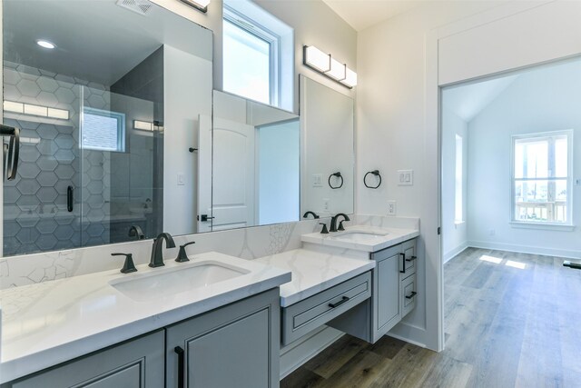 bathroom featuring hardwood / wood-style floors, vanity, a wealth of natural light, and an enclosed shower