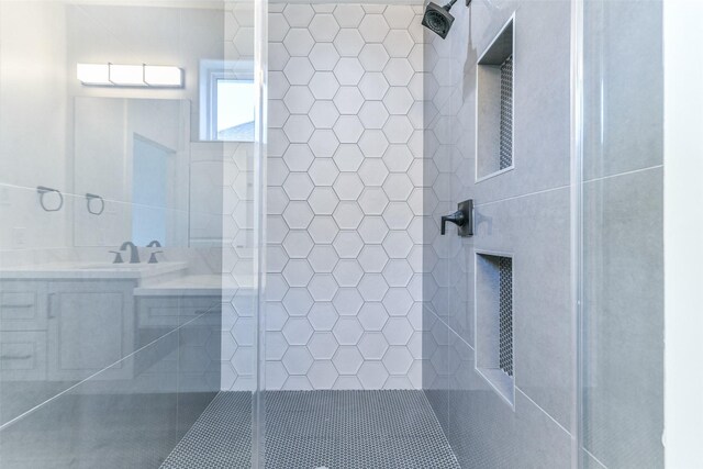 bathroom featuring vanity and tiled shower