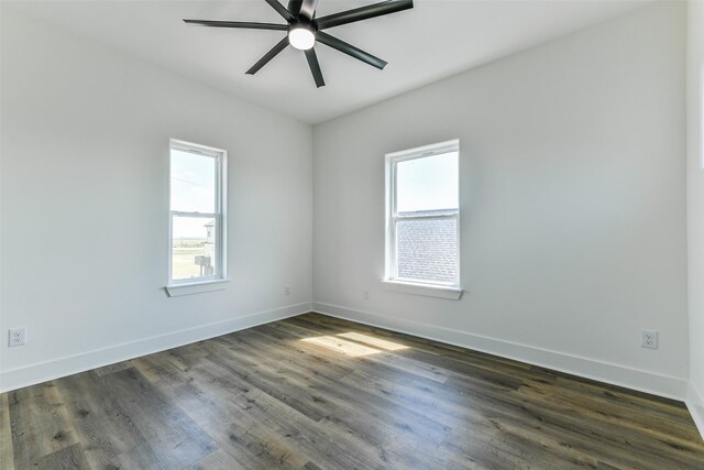 unfurnished room with ceiling fan and dark wood-type flooring