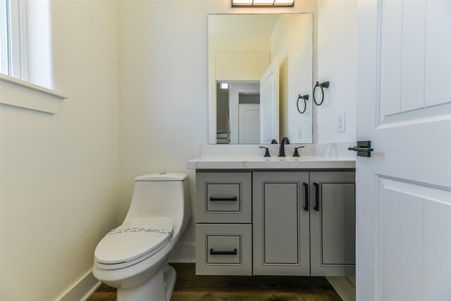 bathroom featuring hardwood / wood-style floors, vanity, and toilet