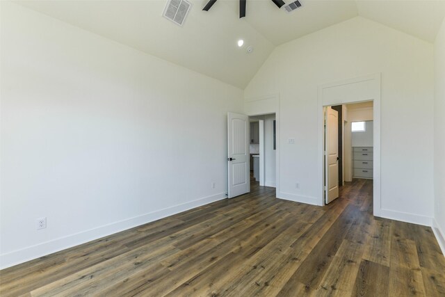 unfurnished bedroom featuring dark wood-type flooring and vaulted ceiling