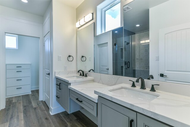 bathroom featuring vanity, wood-type flooring, and walk in shower