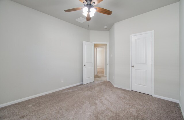 unfurnished bedroom with ceiling fan and light colored carpet