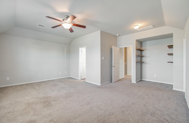 unfurnished bedroom with ceiling fan, light colored carpet, and vaulted ceiling