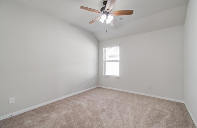 carpeted empty room with ceiling fan and lofted ceiling