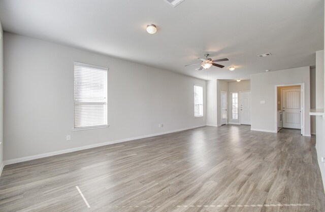 unfurnished room with light hardwood / wood-style flooring and ceiling fan