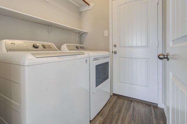 laundry area featuring dark wood-type flooring and washer and dryer