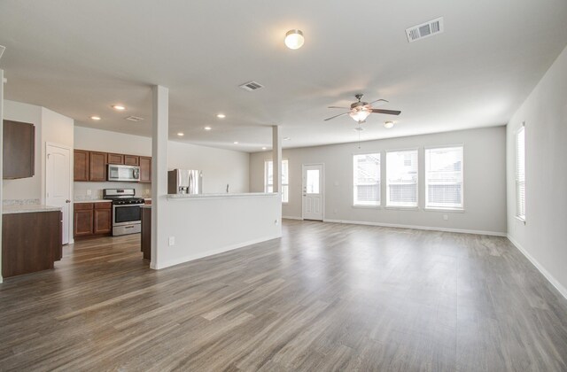 unfurnished living room featuring dark hardwood / wood-style flooring and ceiling fan