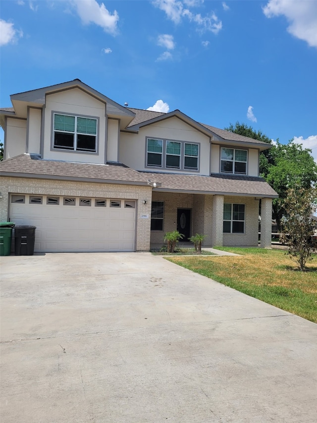 view of front of house with a garage and a front yard