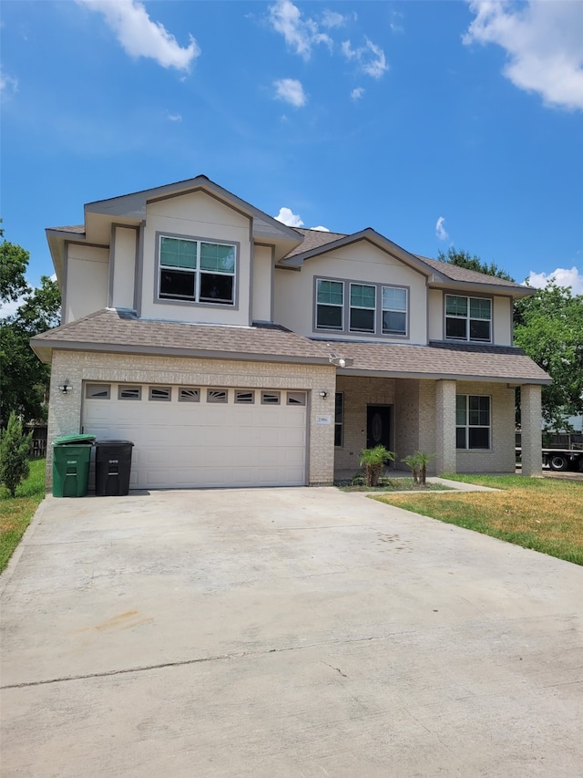 view of front facade featuring a front yard and a garage