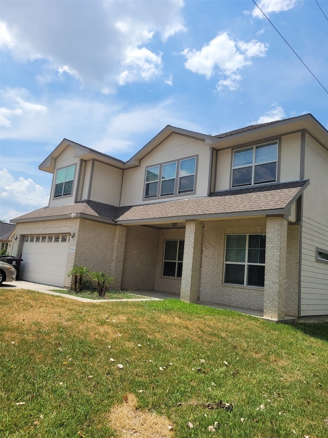 view of front of home with a front yard and a garage