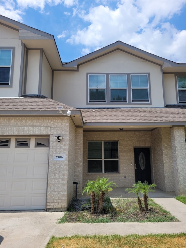 townhome / multi-family property featuring a garage