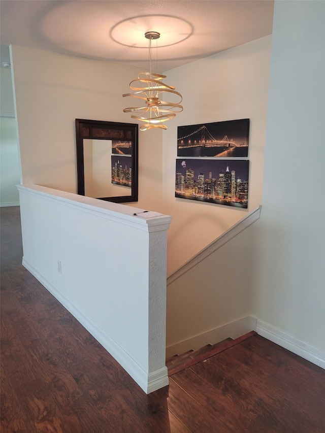 hall with a chandelier and dark hardwood / wood-style floors