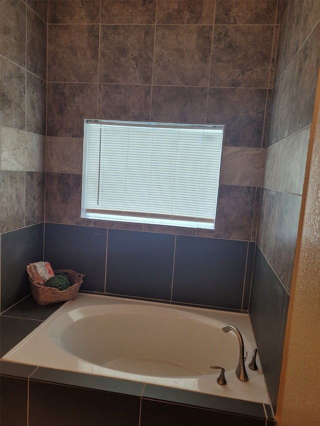 bathroom featuring a relaxing tiled tub