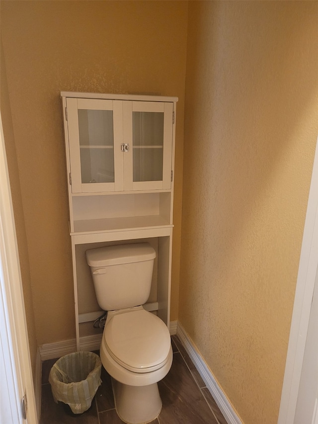 bathroom with hardwood / wood-style flooring and toilet