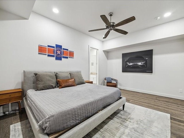 bedroom with hardwood / wood-style flooring, ensuite bath, and ceiling fan