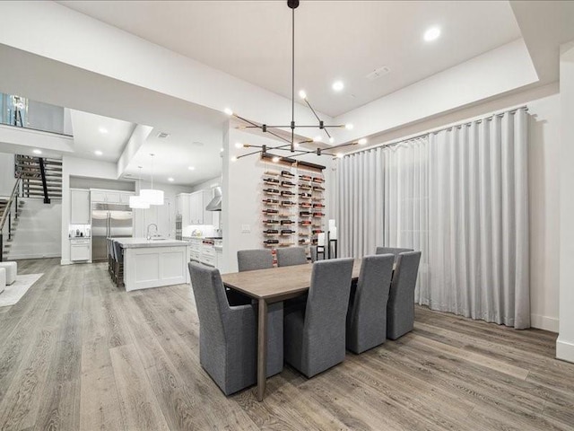 dining room with light hardwood / wood-style floors and sink