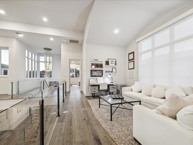 living room with hardwood / wood-style flooring and vaulted ceiling