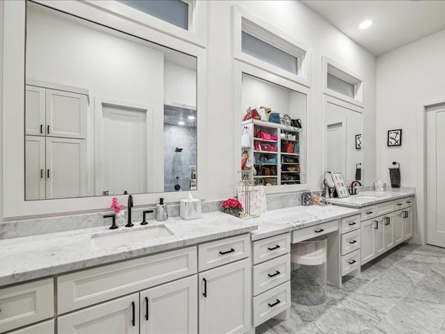 bathroom featuring vanity and a shower with door