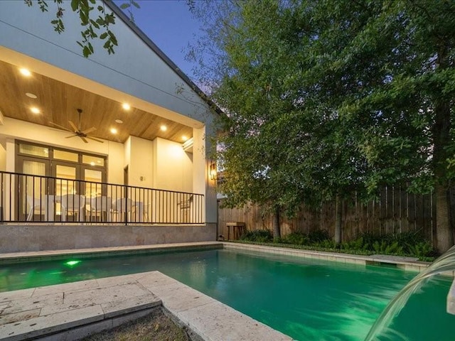 view of swimming pool featuring ceiling fan