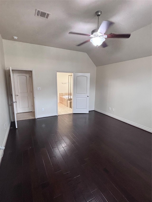 unfurnished room featuring a textured ceiling, ceiling fan, lofted ceiling, and dark wood-type flooring