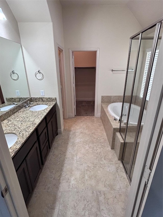 bathroom featuring vanity and separate shower and tub