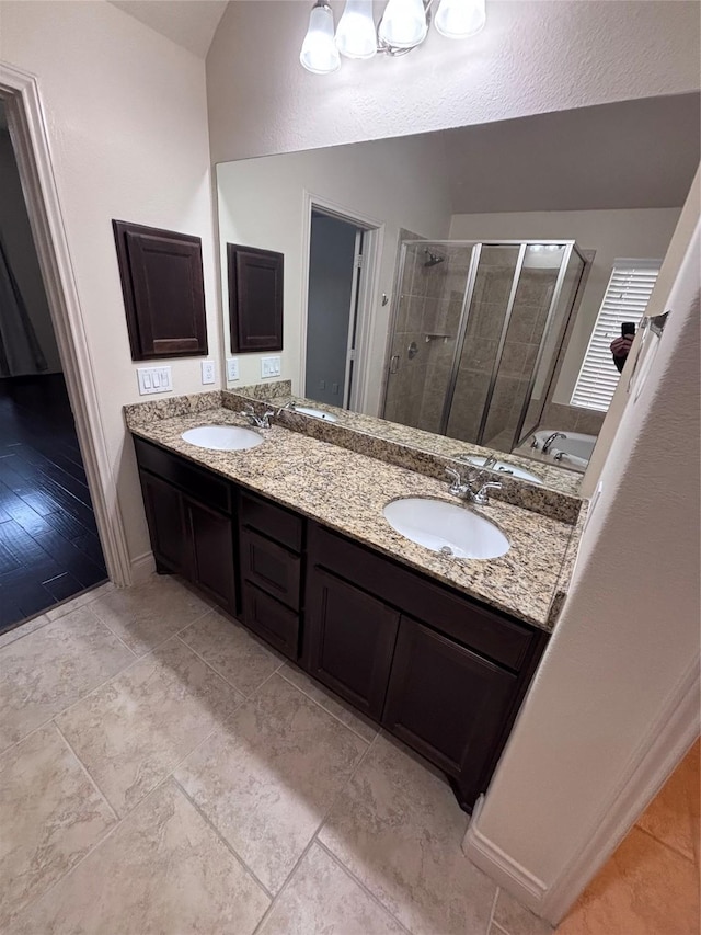 bathroom featuring vanity and shower with separate bathtub