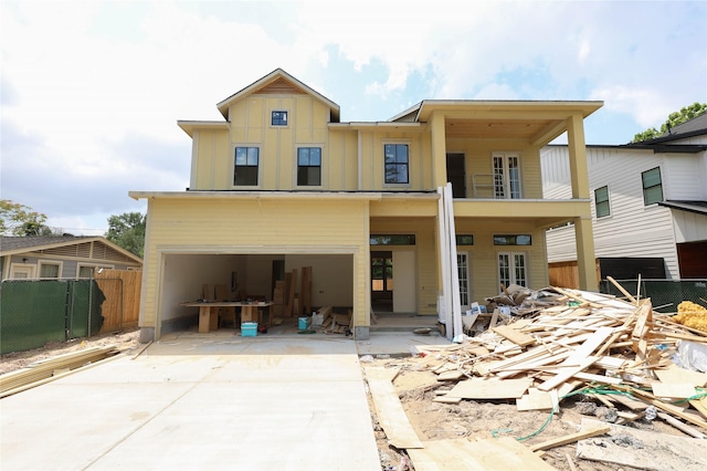 1439 Martin St, Houston, TX 77018 - back of property with concrete driveway, board and batten siding, an attached garage, and fence