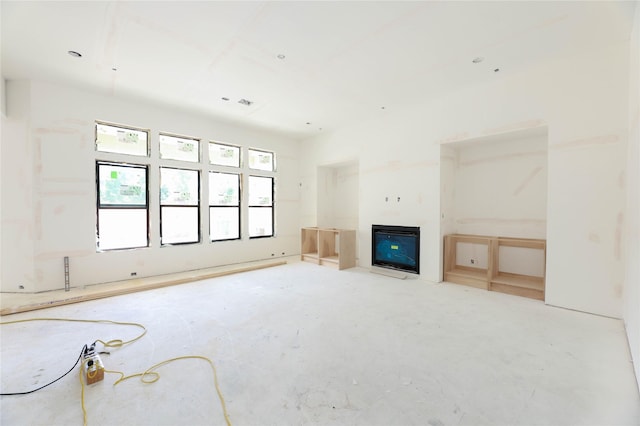 1439 Martin St, Houston, TX 77018 - unfurnished living room featuring a fireplace and concrete flooring