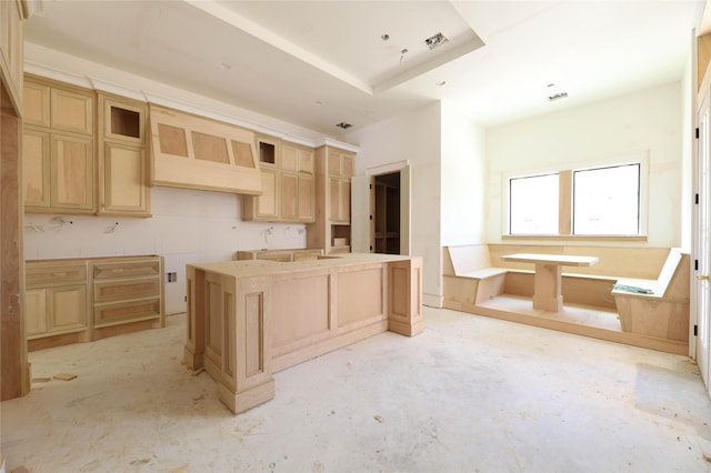 1439 Martin St, Houston, TX 77018 - kitchen with unfinished concrete floors, light brown cabinets, and glass insert cabinets