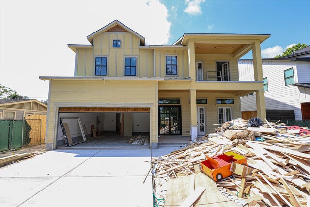1439 Martin St, Houston, TX 77018 - view of front of property featuring driveway, board and batten siding, a garage, and a balcony