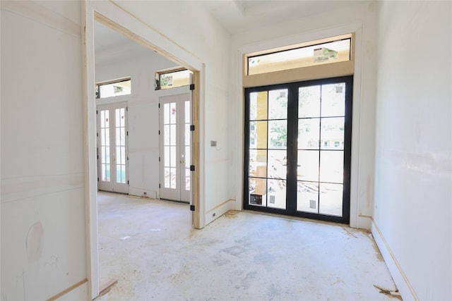 1439 Martin St, Houston, TX 77018 - foyer entrance with french doors, healthy amount of natural light, and unfinished concrete flooring