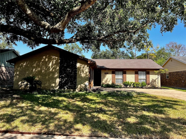 ranch-style home with a front lawn