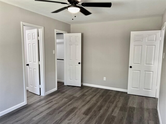 unfurnished bedroom featuring ceiling fan and dark hardwood / wood-style floors