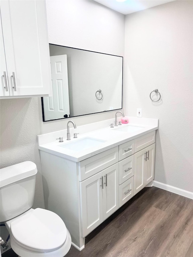 bathroom featuring hardwood / wood-style floors, vanity, and toilet