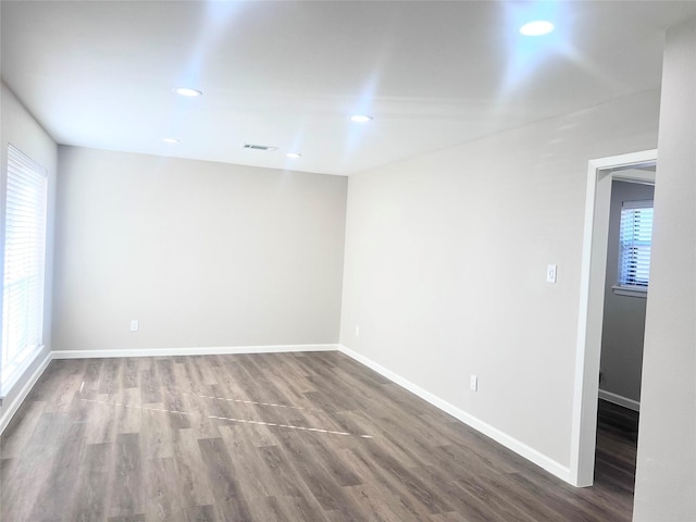 unfurnished room with wood-type flooring